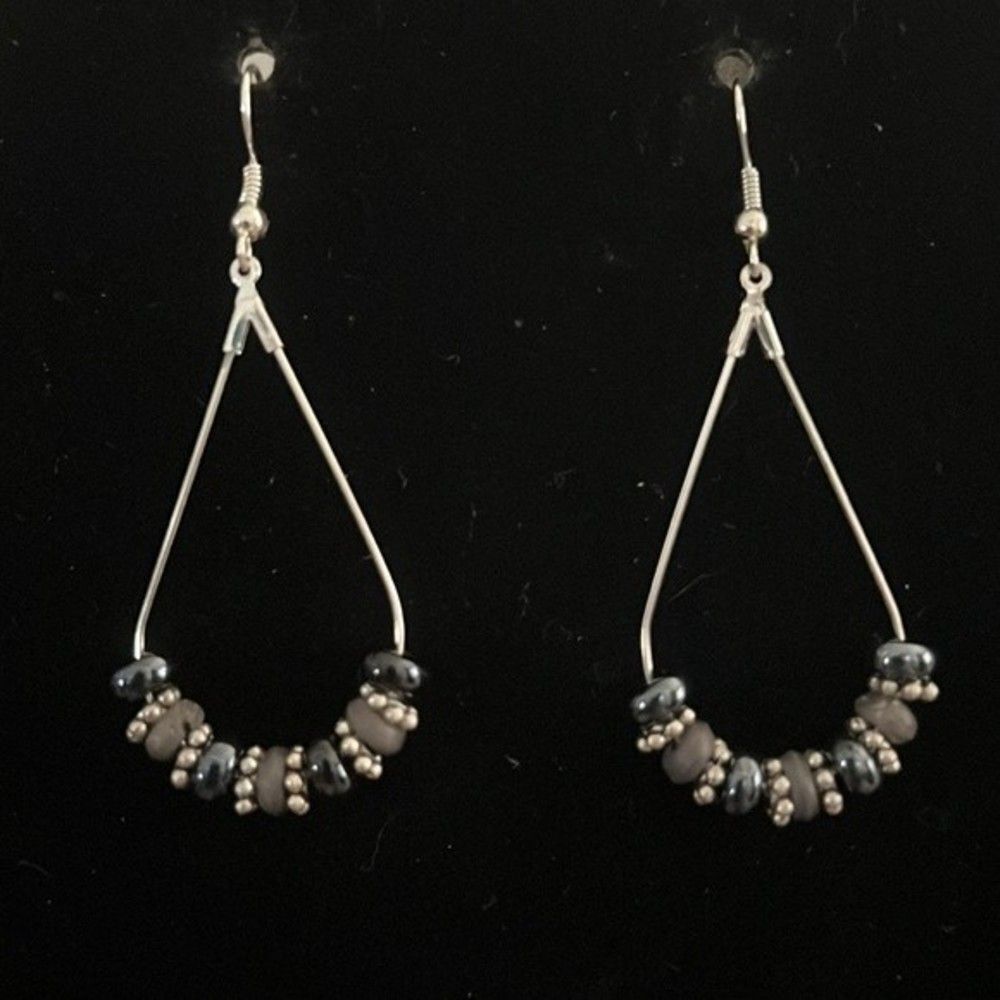 Handcrafted silver tone earrings with black, grey and silver beading.